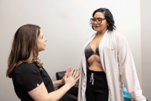 Dr. Ford giving a patient a breast examination looking for rupture or other implant complications in Murrieta