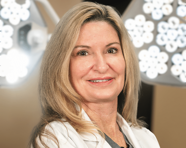 Dr Debbie Taurek in the lab coat headshot