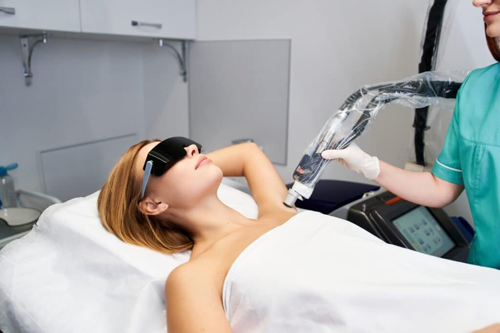 patient receiving laser hair removal on armpits